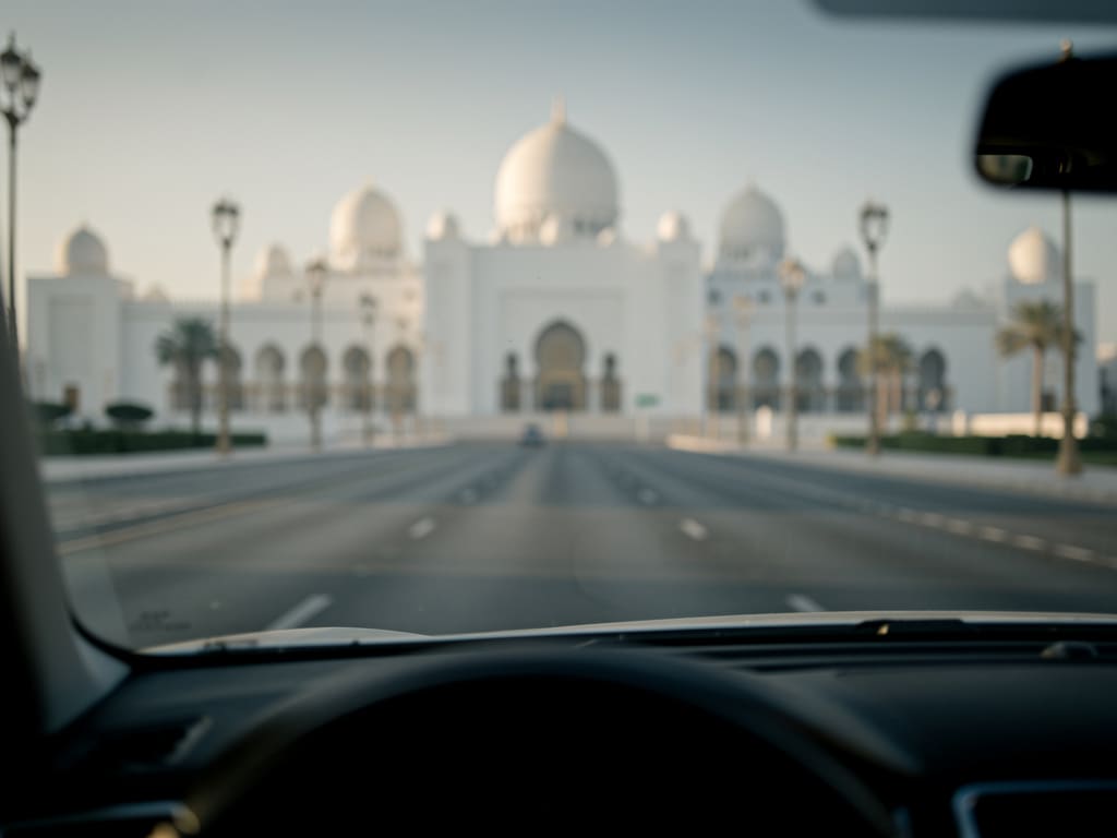 Road approaching white palace architecture in Abu Dhabi
